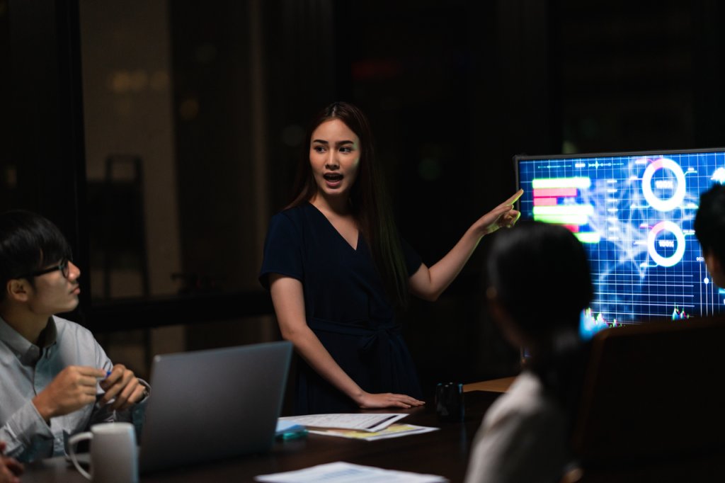 Futuristic workplace showing AI HR analytics alongside team collaboration tools.
