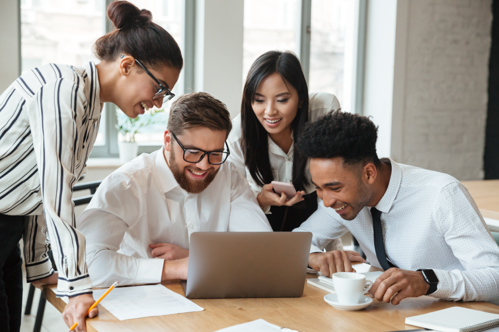 Happy diverse employees collaborating in a healthy workplace environment
