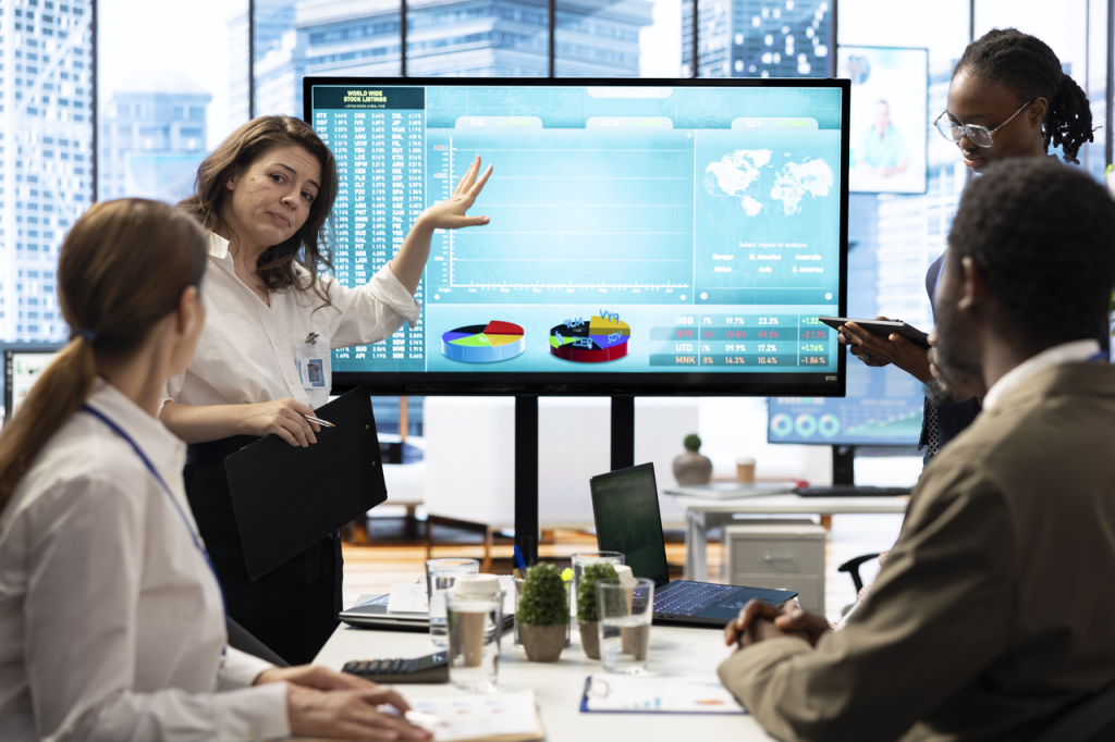 Business team collaborating with AI software insights on screen
