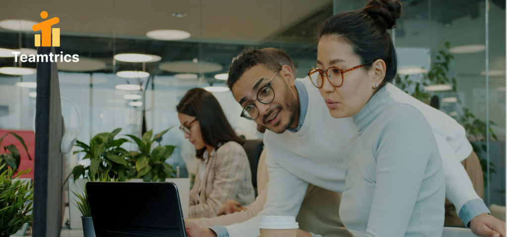 Suggested Image Alt Text: A diverse team in a hybrid work setting using team collaboration tools and hybrid employee review software for a transparent performance review.