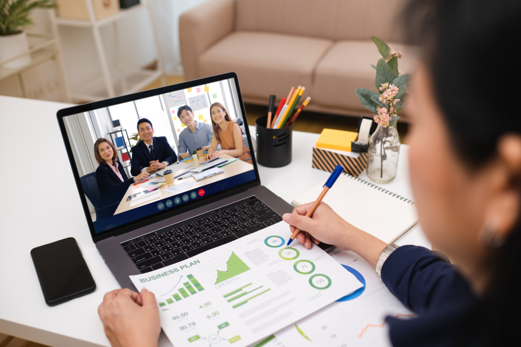 Hybrid work setup showing office and home workers collaborating via cloud-based tools